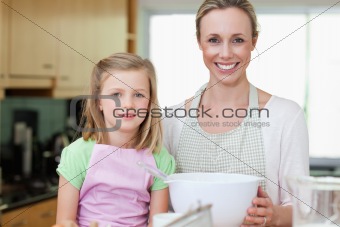 Mother and daughter with bowl in the kitchen