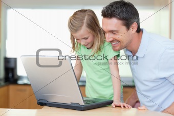 Father and daughter with laptop