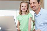 Father and daughter together with laptop