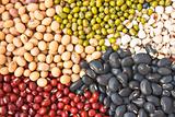 Various colorful dried legumes beans as background