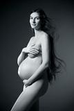 nude pregnant woman with very long brown hair 