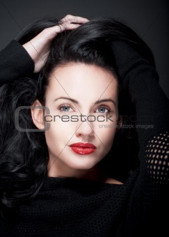 portrait of beautiful woman with dark hair and blue eyes
