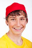 portrait of a teenage boy in red baseball cap smiling -isolated on white
