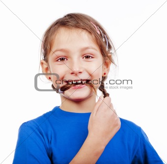 portrait of a little girl biting her braid - isolated on white