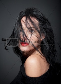 portrait of beautiful woman with dark hair and blue eyes