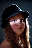 dramatic portrait of a twelve years old girl with hat