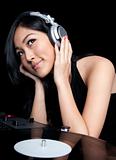 Female DJ listening to music