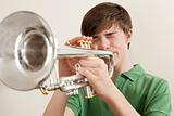 Teen playing silver trumpet