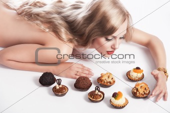 blond sexy girl eating pastry, she looks pastries