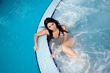 Attractive sexy brunette swimming in a pool