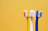 Toothbrushes On Yellow