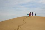 Walking women on the sand
