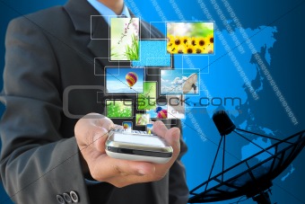 businessman hand holding streaming images virtual buttons and satellite dish antennas