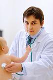 Pediatric doctor checking baby  using a stethoscope 
