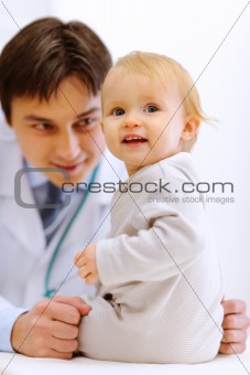 Portrait of baby on examination at pediatrician cabinet
