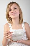 happy child with a bowl of milk porridge