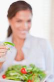 Portrait of a young woman eating a salad