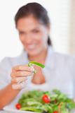 Portrait of a smiling woman eating a salad
