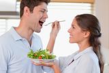Accomplice couple tasting a salad