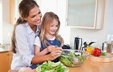 Mother and her daughter preparing a salad