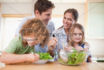 Happy family preparing a salad