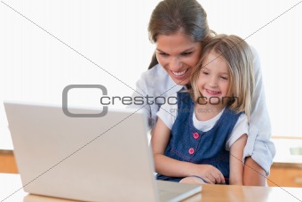 Mother and her daughter using a notebook