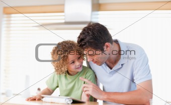 Young boy and his father using a tablet computer