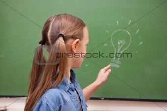 Schoolgirl pointing at a bulb