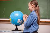 Schoolgirl looking at a globe