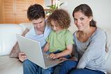 Young family using a laptop