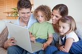 Serene family using a laptop