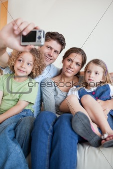 Portrait of a family taking a photo of themselves