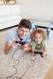 Portrait of a boy and his father playing video games