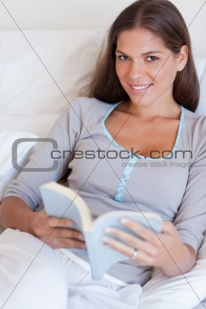 Portrait of an attractive woman holding a book