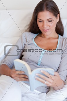 Portrait of an attractive woman reading a book