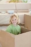 Boy hiding in cardboard box