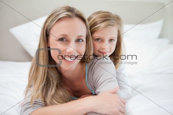 Girl lying on her mothers back