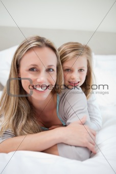 Girl laying on her mothers back