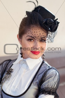 Portrait of a fresh and lovely woman wearing a hat with a veil