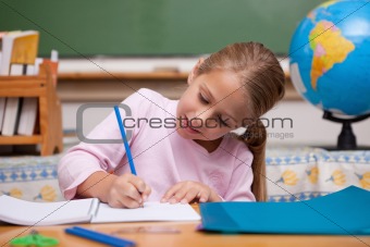 Happy schoolgirl writing