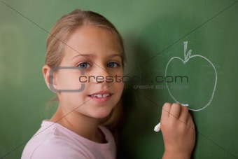 Schoolgirl drawing an apple