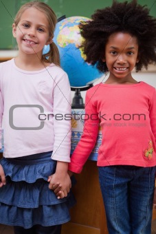 Portrait of schoolgirls holding hands