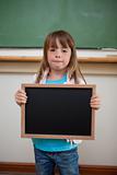 Portrait of a little girl holding a school slate