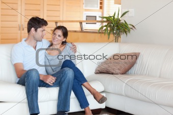 Smiling couple sitting on a couch