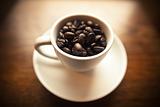 Coffee beans in white coffee mug