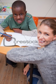 Portrait of a teacher explaining something to a young schoolboy