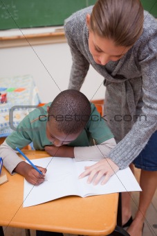 Portrait of a teacher explaining something to a focused schoolboy