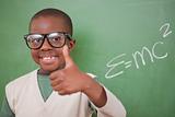 Schoolboy posing with the the mass-energy equivalence formula and the thumb up