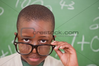 Schoolboy looking over his glasses