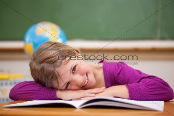 Schoolgirl leaning on her desk